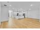 Open concept living room with hardwood floors and kitchen view at 155 Pearl St, Auburndale, FL 33823