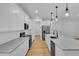 White kitchen with stainless steel appliances and an island with seating at 155 Pearl St, Auburndale, FL 33823