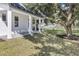Charming front porch with large tree and gray pavers at 155 Pearl St, Auburndale, FL 33823