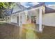 Large covered patio with white columns and paver floor at 155 Pearl St, Auburndale, FL 33823