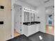 Bathroom features double vanity, hexagon tile floor, and glass shower at 155 Pearl St, Auburndale, FL 33823