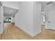 Bright hallway with wood flooring and shiplap accent wall at 155 Pearl St, Auburndale, FL 33823