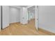 Light and airy bedroom with hardwood floors and open doorway at 155 Pearl St, Auburndale, FL 33823