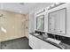 Modern bathroom with double vanity, large mirror, and walk-in shower at 155 Pearl St, Auburndale, FL 33823