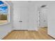 Bedroom with hardwood floors, double doors, and window at 155 Pearl St, Auburndale, FL 33823
