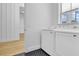 Laundry room with washer, dryer, and black and white tile floor at 155 Pearl St, Auburndale, FL 33823