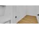 Small pantry with light colored wood flooring and white walls at 155 Pearl St, Auburndale, FL 33823