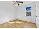 Bright bedroom with hardwood floors, double doors, and window at 155 Pearl St, Auburndale, FL 33823