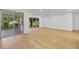 Spacious living area with hardwood floors and sliding glass doors leading outside at 155 Pearl St, Auburndale, FL 33823
