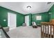 Green-walled bedroom with crib and rocking chair at 162 Harwood Cir, Kissimmee, FL 34744