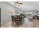 Bright dining room with wood table, leather chairs and bench at 162 Harwood Cir, Kissimmee, FL 34744