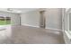 Spacious living room with wood-look tile floors, high ceilings and access to backyard at 1877 Snapper Dr, Kissimmee, FL 34759
