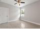 Light-filled bedroom, featuring a ceiling fan and tile flooring at 1877 Snapper Dr, Kissimmee, FL 34759