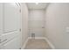 Bright laundry room with washer, dryer hookups, and shelving at 1877 Snapper Dr, Kissimmee, FL 34759