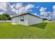 White house with backyard and grassy lawn at 1877 Snapper Dr, Kissimmee, FL 34759