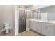 Elegant bathroom with double vanity and frameless shower at 1877 Snapper Dr, Kissimmee, FL 34759