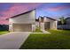 Modern home exterior at dusk, showcasing contemporary design at 1877 Snapper Dr, Kissimmee, FL 34759
