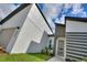Modern home exterior with gray and white accents, attached garage, and landscaped front yard at 1877 Snapper Dr, Kissimmee, FL 34759