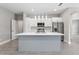 Modern kitchen with white cabinets, stainless steel appliances, and a large kitchen island at 1877 Snapper Dr, Kissimmee, FL 34759