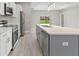 Modern kitchen with white cabinets, stainless steel appliances and large kitchen island at 1877 Snapper Dr, Kissimmee, FL 34759
