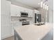 Modern kitchen with white cabinets, stainless steel appliances and a large center island at 1877 Snapper Dr, Kissimmee, FL 34759