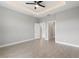 Modern bedroom with coffered ceiling and tile floors at 1877 Snapper Dr, Kissimmee, FL 34759
