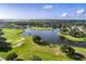 Aerial view of the golf course community and lake at 2108 Drive Way, Kissimmee, FL 34746