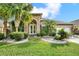 Charming single-story home with stone exterior, lush landscaping, and a two-car garage at 2108 Drive Way, Kissimmee, FL 34746