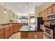 Island kitchen with granite countertops and wood cabinets at 2108 Drive Way, Kissimmee, FL 34746
