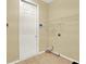 Laundry room with shelving, door and tile flooring at 2108 Drive Way, Kissimmee, FL 34746