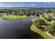 Aerial view of the golf course community and lake at 2108 Drive Way, Kissimmee, FL 34746