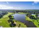 Aerial view of the golf course with a large lake at 2108 Drive Way, Kissimmee, FL 34746