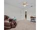 Bedroom with a massaging chair, ceiling fan, and a desk at 21523 Queen Anne Ct, Leesburg, FL 34748