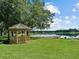 Relaxing gazebo by the lake with a pier at 21523 Queen Anne Ct, Leesburg, FL 34748
