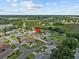 Aerial view of single-story home in quiet neighborhood with lush landscaping at 21523 Queen Anne Ct, Leesburg, FL 34748
