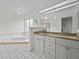 Bathroom boasts dual vanities, granite countertops, and a large soaking tub at 21523 Queen Anne Ct, Leesburg, FL 34748