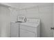 Laundry room with washer, dryer, and ample shelving at 21523 Queen Anne Ct, Leesburg, FL 34748