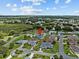 An aerial view of a single-story house situated in a residential neighborhood at 21523 Queen Anne Ct, Leesburg, FL 34748