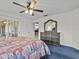 Main bedroom with a dresser, ceiling fan and access to the backyard at 21523 Queen Anne Ct, Leesburg, FL 34748