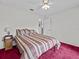 Bedroom with a ceiling fan, carpet, and a view of the backyard at 21523 Queen Anne Ct, Leesburg, FL 34748