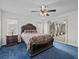 Bedroom with sliding glass doors to screened porch and ceiling fan at 21523 Queen Anne Ct, Leesburg, FL 34748