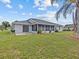 House exterior showcasing a large backyard and screened porch at 21523 Queen Anne Ct, Leesburg, FL 34748