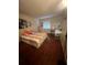 Cozy bedroom with a double bed, desk, and wood floors at 238 Riverbend Dr # 107, Altamonte Springs, FL 32714