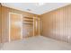 Bedroom with wood paneling, two closets, and neutral carpet at 2900 Lake Arnold Pl, Orlando, FL 32806