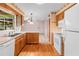 Galley kitchen with wood cabinets and white appliances at 2900 Lake Arnold Pl, Orlando, FL 32806