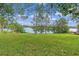 Peaceful lake view from a grassy lakeside lot with mature trees at 2900 Lake Arnold Pl, Orlando, FL 32806