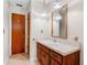 Bathroom with wood vanity and large mirror at 2900 Lake Arnold Pl, Orlando, FL 32806