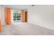 Spacious living room featuring sliding glass doors leading to the outdoors at 2900 Lake Arnold Pl, Orlando, FL 32806