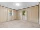 Bedroom with wood paneling, two windows, and neutral carpet at 2900 Lake Arnold Pl, Orlando, FL 32806