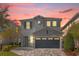 Two-story house with gray siding, stone accents, and a two-car garage at 365 Southfield St, Kissimmee, FL 34747